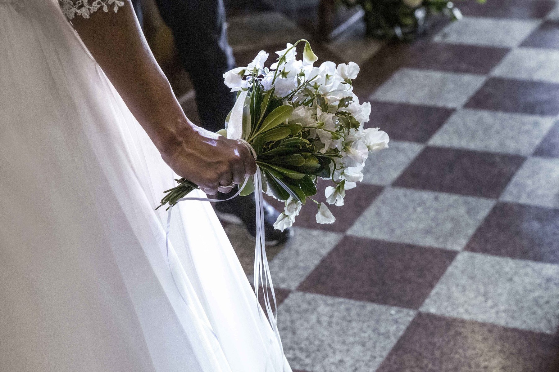 Bouquet sposa mano pavimento a scacchi marmo